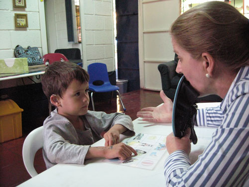 a boy and teacher doing school work